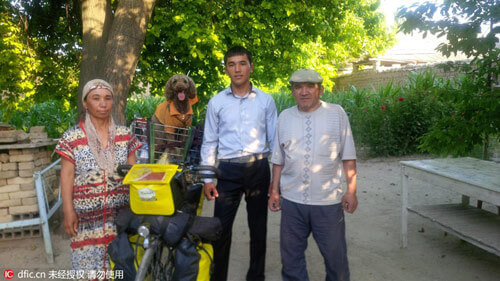 Chàng thanh niên cùng chú chó cưng chụp ảnh kỷ niệm với người dân địa phương ở  Cộng hòa Uzbekistan ngày 25/6/2014